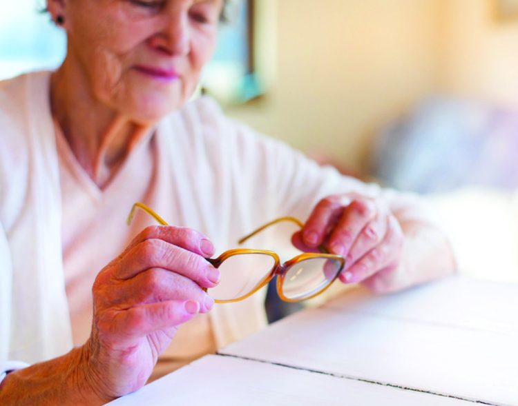 women looking at her glasses