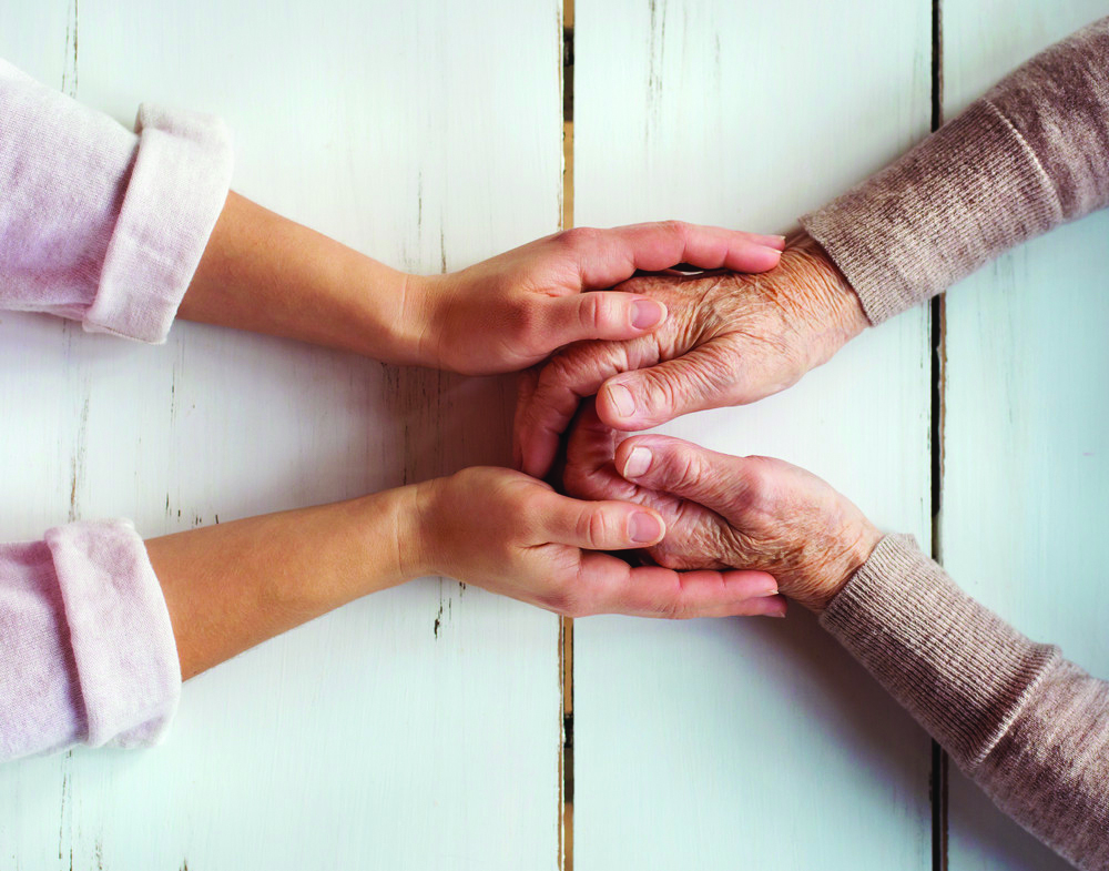 offering a caring hand to a senior